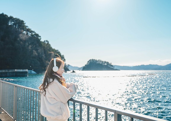 海を眺める女性の写真